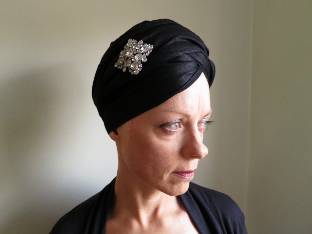 Breast cancer patient Amy Czerniec modeling a head wrap during chemotherapy