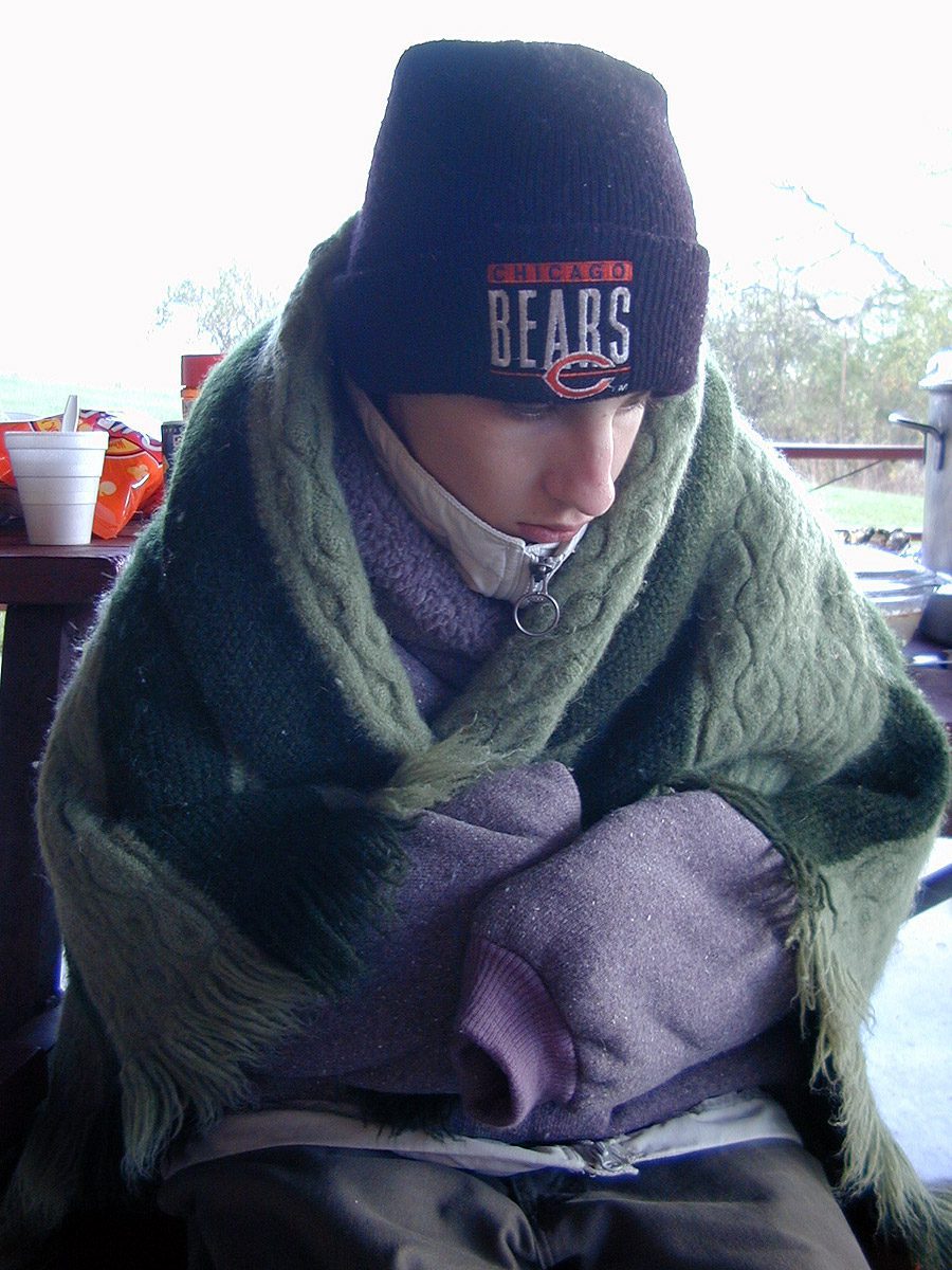 Bundled up in blankets and Chicago Bears hat. Erik shivers at Silver Lake Park, Salem, Wisconsin