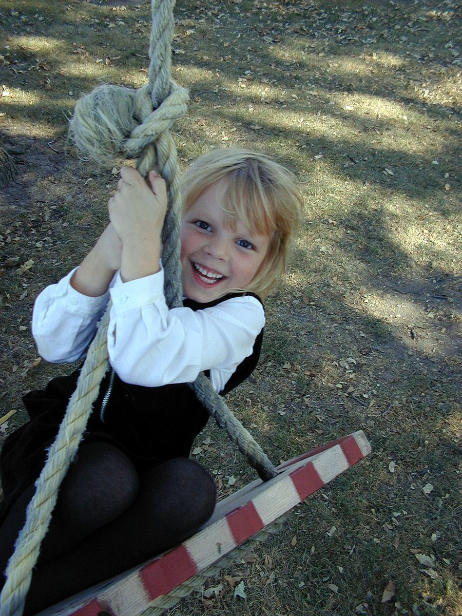 Girl on a backyard swing in Wisconsin