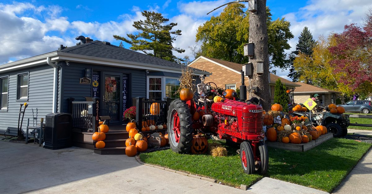 House in Racine, Wisconsin decorated for Halloween with tractors and pumpkins.