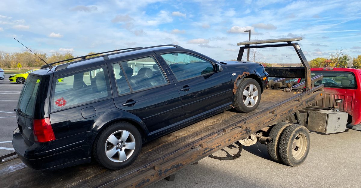 2003 Volkswagen Jetta TDI Wagon loaded on a flatbed tow truck.