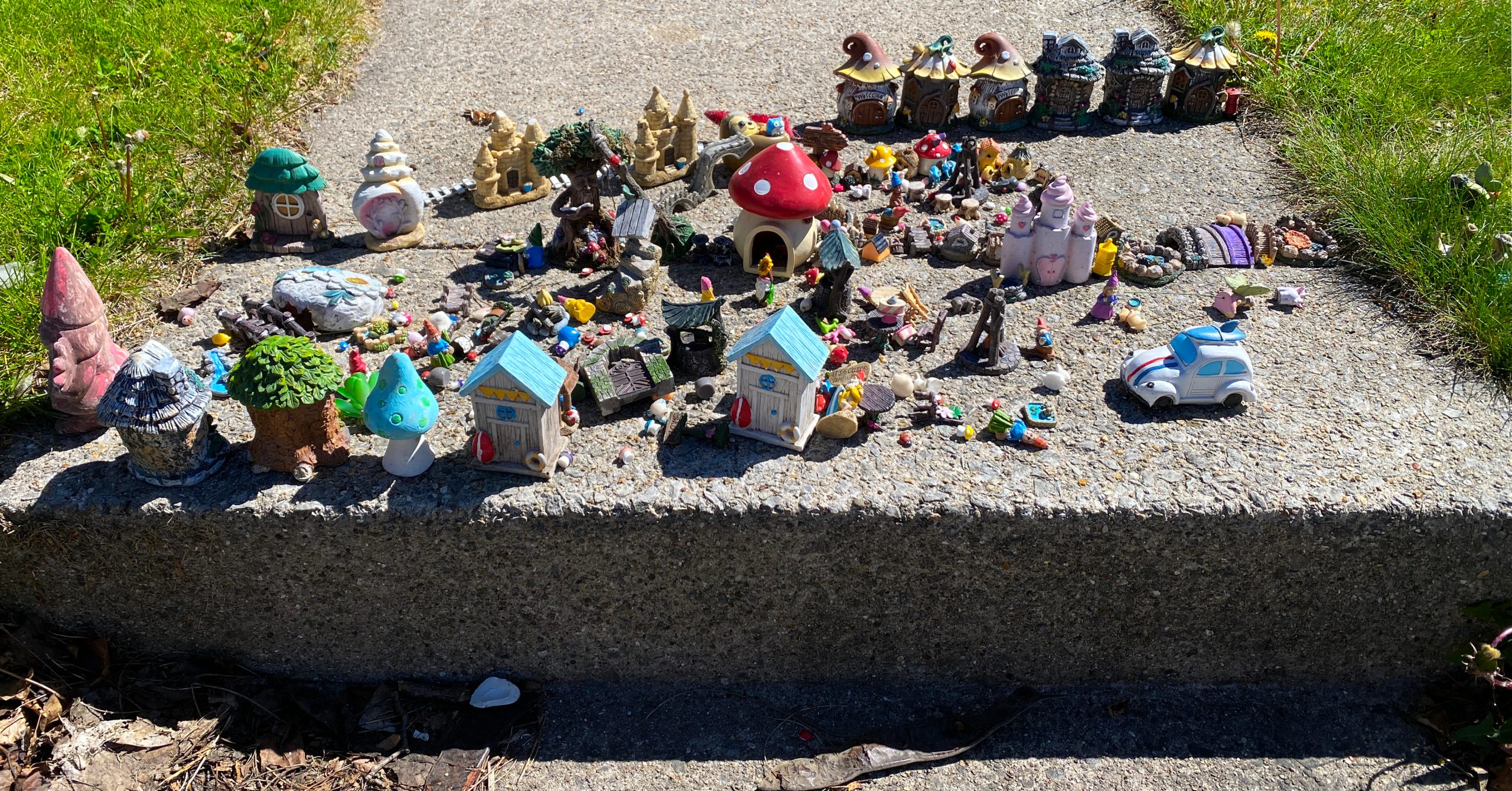 An assortment of gnomish miniatures displayed on a front walk in Racine, Wisconsin.