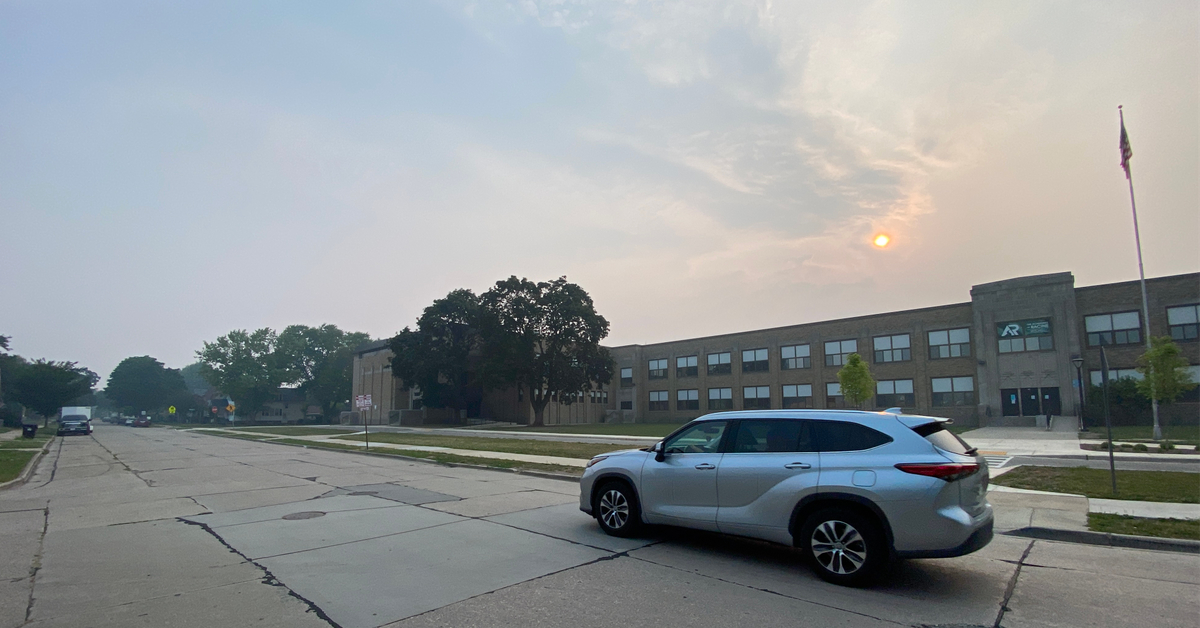 Wildfire smoke obscures the sunrise at Mitchell School in Racine, Wisconsin.